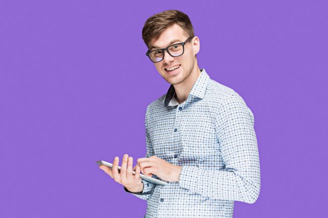 Photo of man with tablet illustrates blog: "Starting a Blog? Avoid These Rookie Mistakes"