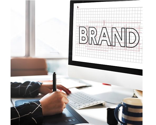 Photo of man drawing beside screen that reads "Brand" illustrates blog: "What Is a Brand Story (and Why It Matters)?"