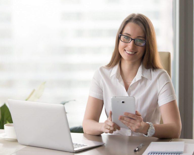 Photo of smiling woman in office illustrates blog: "7 Content Marketing Tips to Supercharge Your Sales in 2022"